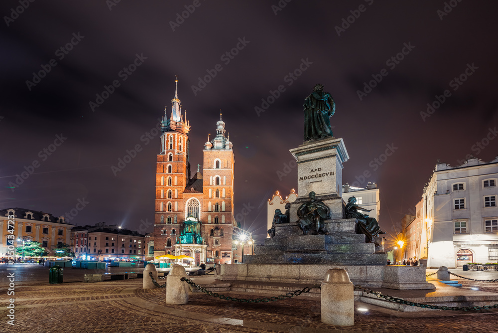 Adam Mickiewicz Monument on Main Market Square in front of  St. Mary's Basilica  in Krakow, Poland at night