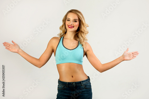 beautiful young girl with slim figure on a gray background © Alexandr