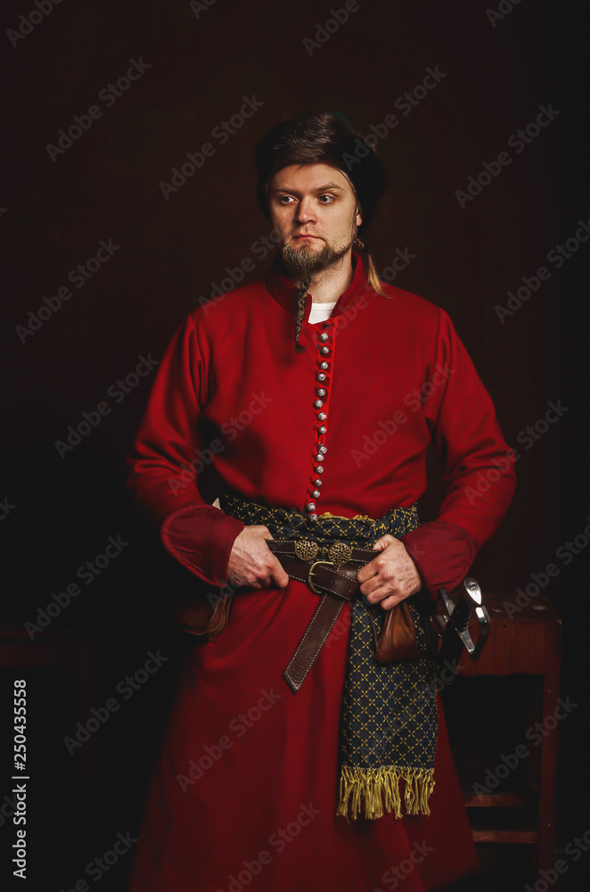 Portrait of a man in a medieval costume on a dark background. Clothes of  the Polish gentry. Stock Photo | Adobe Stock