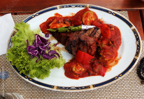 Grilled beef steak with asparagus, lettuce,red cabbage and tomato sauce