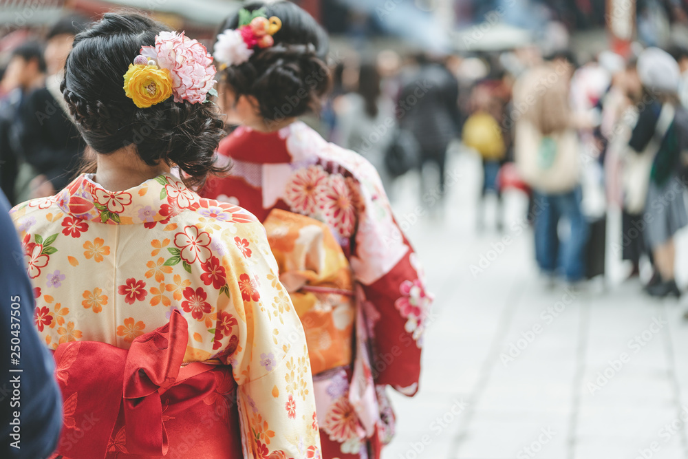 Young girl wearing Japanese kimono standing in front of Sensoji Temple in Tokyo, Japan. Kimono is a Japanese traditional garment. The word 