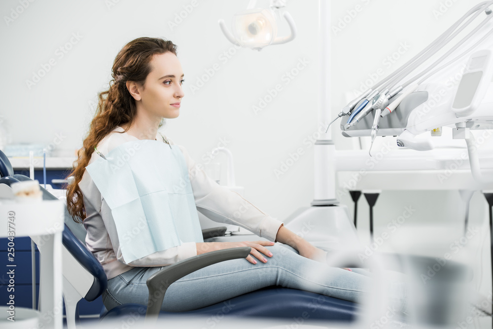 cheerful woman smiling while sitting on chair in dental clinic cheerful woman smiling while sitting on chair in dental clinic