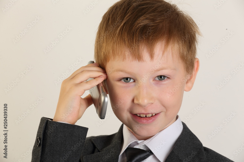 portrait, boy, child, child with a phone, schoolboy with a phone, artist, actor, boy actor, young model, portrait boy, school suit, school uniform, tie, conversation, blond, posing, studio portrait, boy, child, child with a phone, schoolboy with a phone, artist, actor, boy actor, young model, portrait boy, school suit, school uniform, tie, conversation, blond, posing, studio
