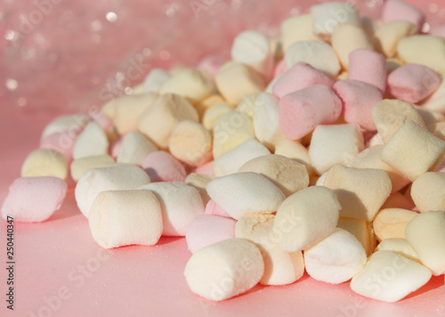 Marshmallows on pink background with copyspace. Flat lay or top view with boke on background.