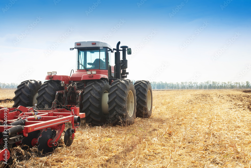 Modern tractor in the field during planting. The concept of agricultural industry. Modern tractor in the field during planting. The concept of agricultural industry.