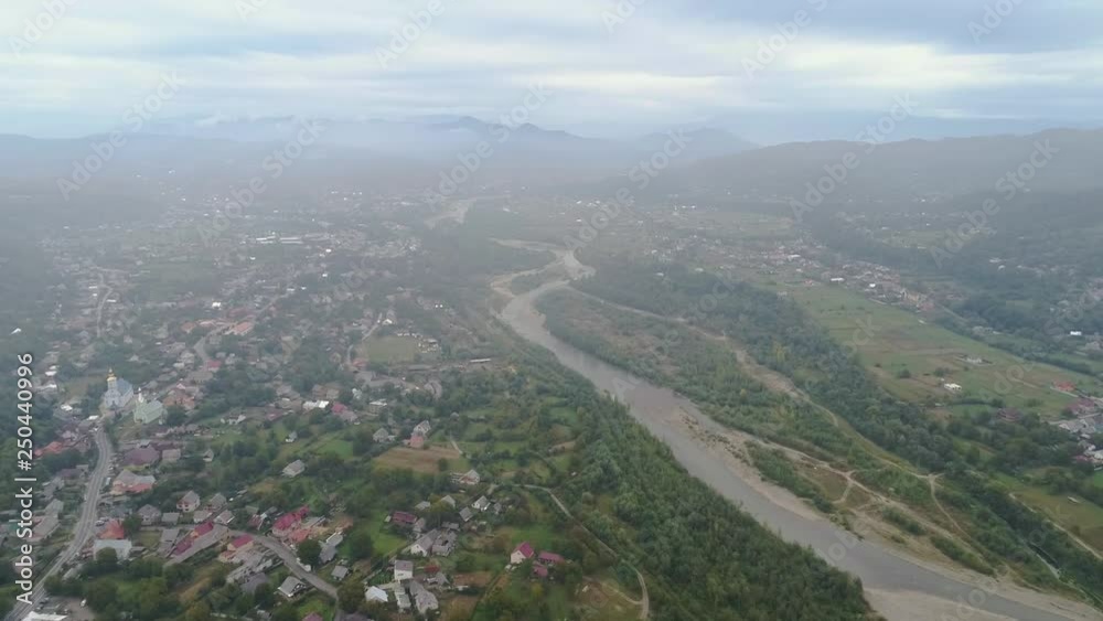 Aerial View: Flying over the small city covered by clouds. Aerial camera shot. Air clouds. 4k Aerial View: Flying over the small city covered by clouds. Aerial camera shot. Air clouds. 4k