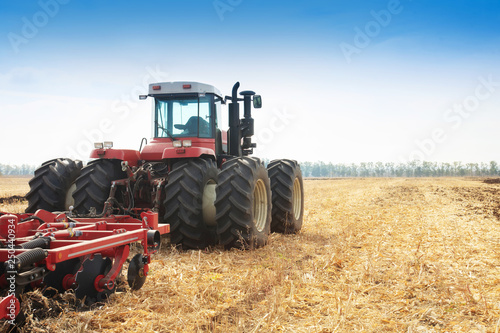 Modern tractor in the field during planting. The concept of agricultural industry.