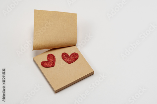Sticky brown paper notes with a heart. On a white background. Valentine's Day © yelantsevv