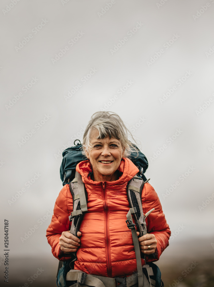Portrait of a female hiker walking carrying a backpack Portrait of a female hiker walking carrying a backpack
