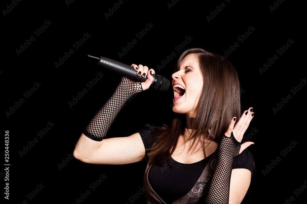 Young Rocker Woman Singing into Microphone - Rock Music Singer Stock Photo  | Adobe Stock