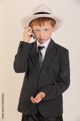 child with a phone, schoolboy with a phone, model, boy, school suit, young model