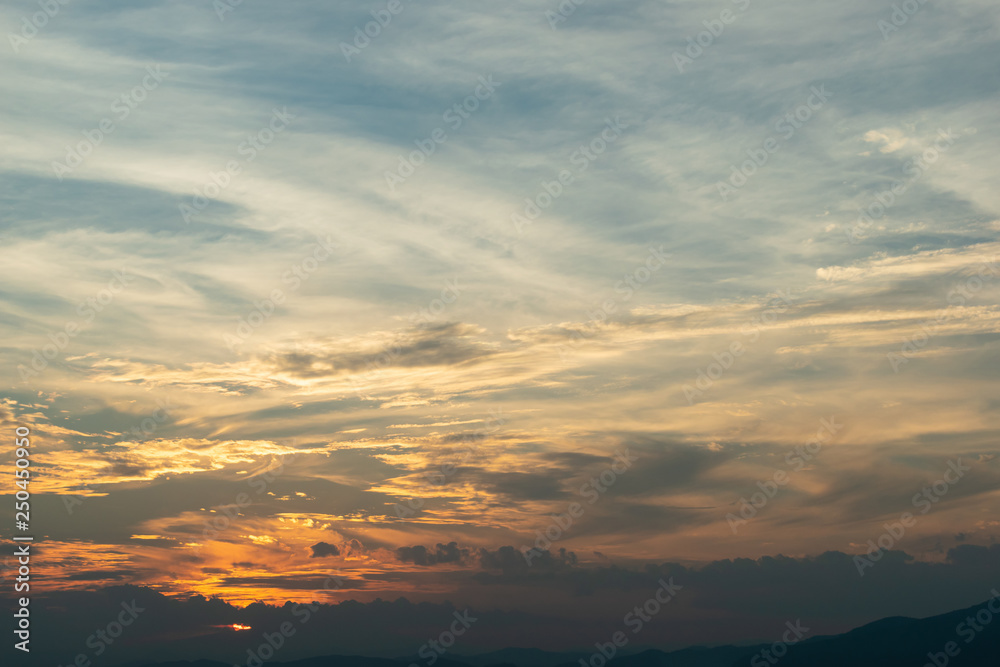 sunlight through cloud on dramatic sunset sky