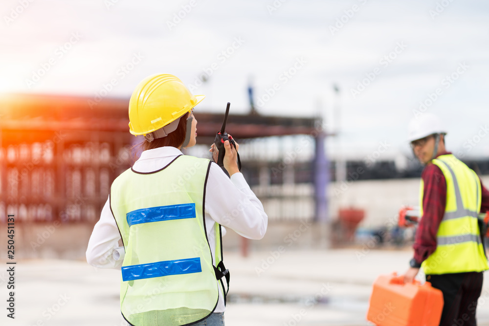 Engineer surveyor using walkie-talkie at construction site foto de Stock |  Adobe Stock