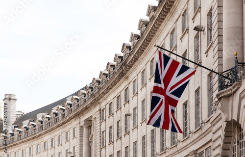 Valokuva British flag on the background of the historic building of London, UK