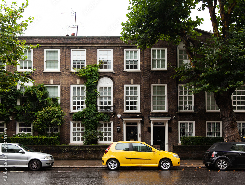 yellow car parked near an English house