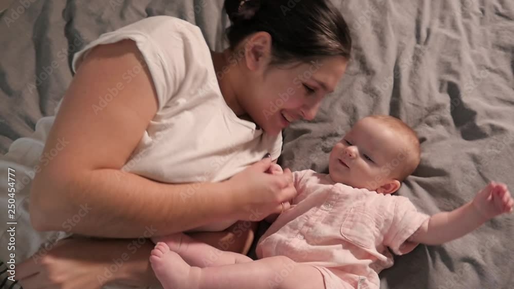 Mother and Child little Baby lying on a Bad happy smiling