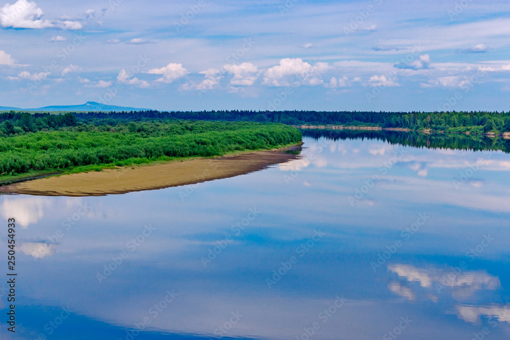 river with reflections of clouds on a summer day