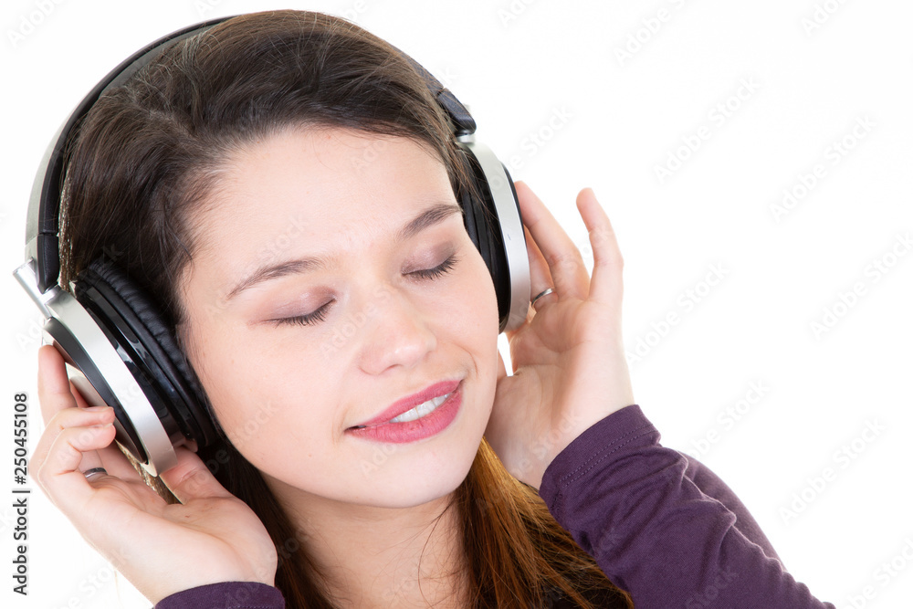 Young beauty brunette young woman enjoying music in headphones in closeup white background Young beauty brunette young woman enjoying music in headphones in closeup white background