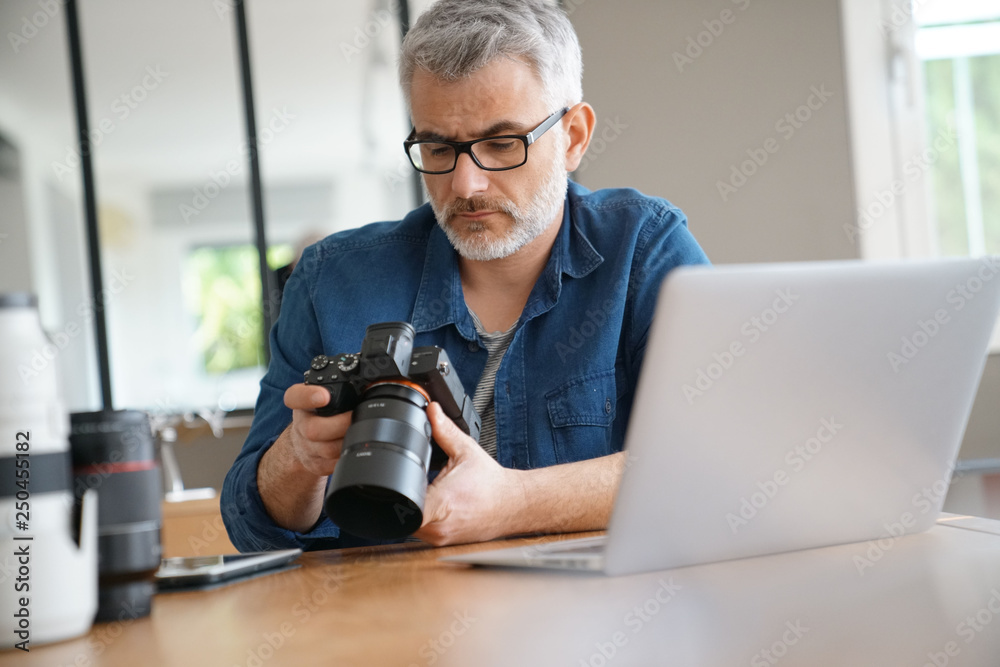 Photographer in office checking shots