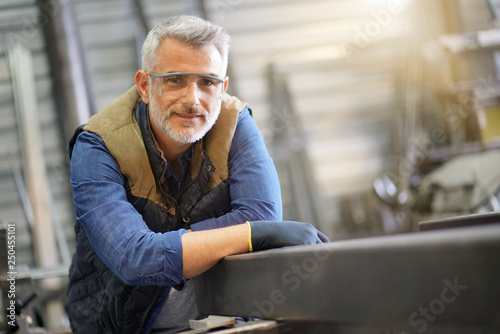 Portrait of middle-aged ironworker in workshop photo