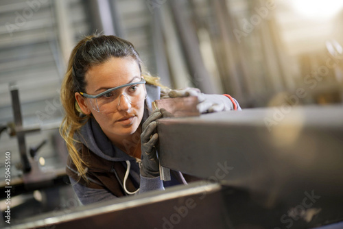 Photography Woman apprentice training in metalwork workshop