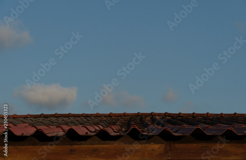 Old roof red color on house under the evening light.