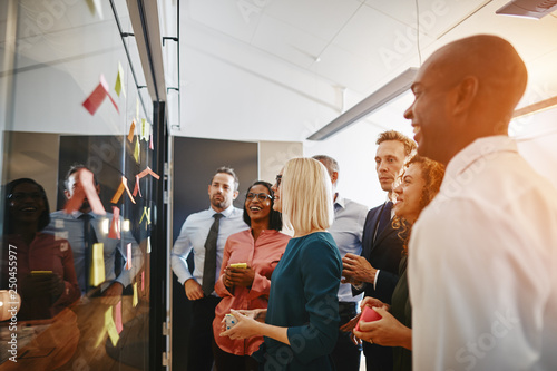 Young businesswoman and her team brainstorming together in an of