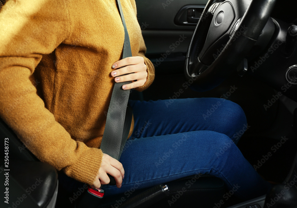 Woman buckling in car seat before passing driving license test Woman buckling in car seat before passing driving license test