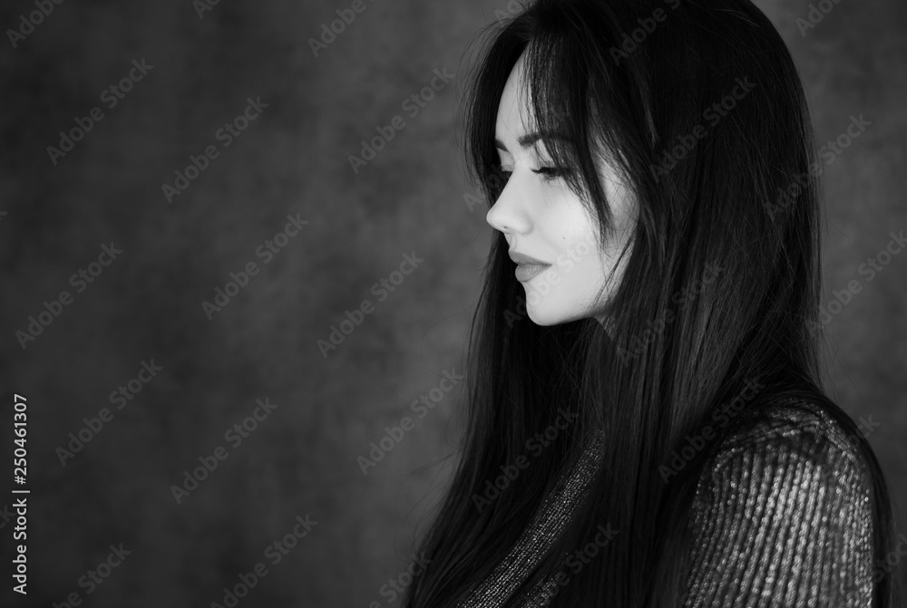 Beautiful brunette girl on a dark background bw Beautiful brunette girl on a dark background bw