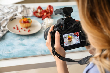 Female food photographer working in home studio