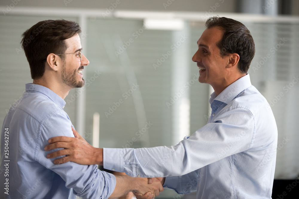 Obraz premium Excited grandmother with granddaughter in headphones listen to music