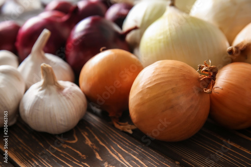 Raw onion with garlic on wooden table