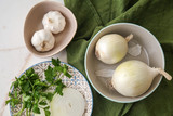 Raw onion with garlic and herbs on light table