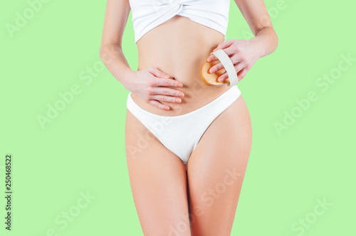Woman with perfect body shape on pastel green background