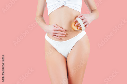 Woman with perfect body shape on pastel pink background