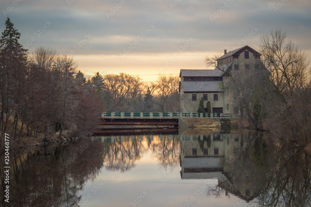 Fototapeta premium Old mill in Cedarburg Wisconsin featuring reflections on the river