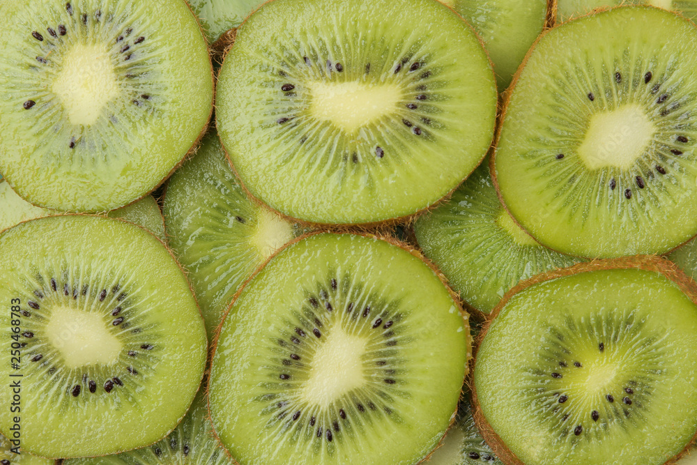 background of kiwi fruit. A lot of ripe kiwi fruit slices. close-up. view from above