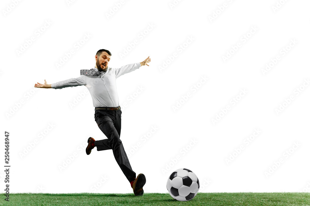 Full length shot of a young businessman playing football isolated on white background.