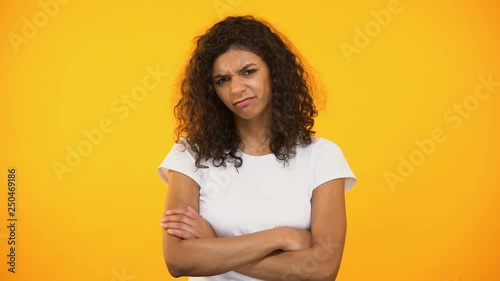 Displeased mixed-race woman looking with disgust and waving hand, poor quality
