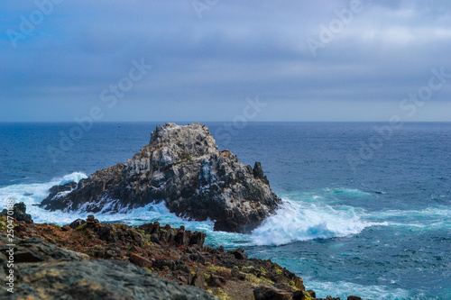 Sea cliffs in blue waters of the Pacific ocean