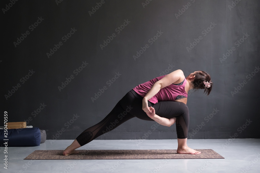 woman doing Extended Side Angle posture, Utthita Parsva Konasana from back side