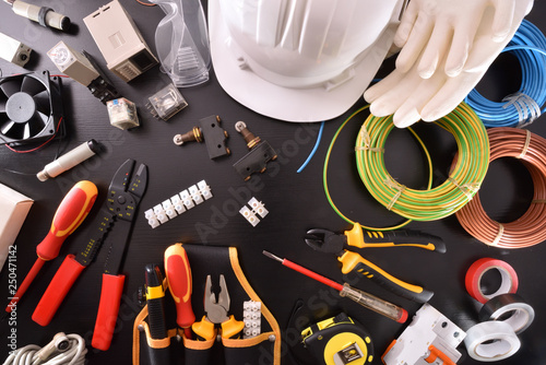 Industrial electricity tools on black table close up top photo