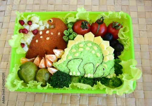 The dinosaur is made of rice. Kyaraben, bento. Creative food for children. photo