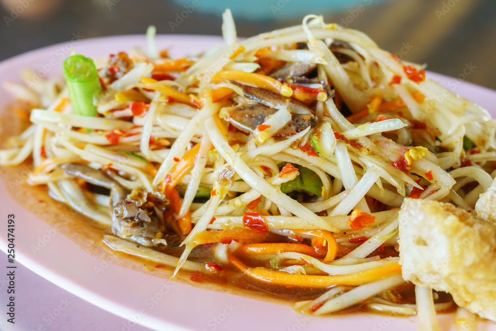 Traditional local Thai food papaya salad with pickled fish sauce close up Traditional local Thai food papaya salad with pickled fish sauce close up