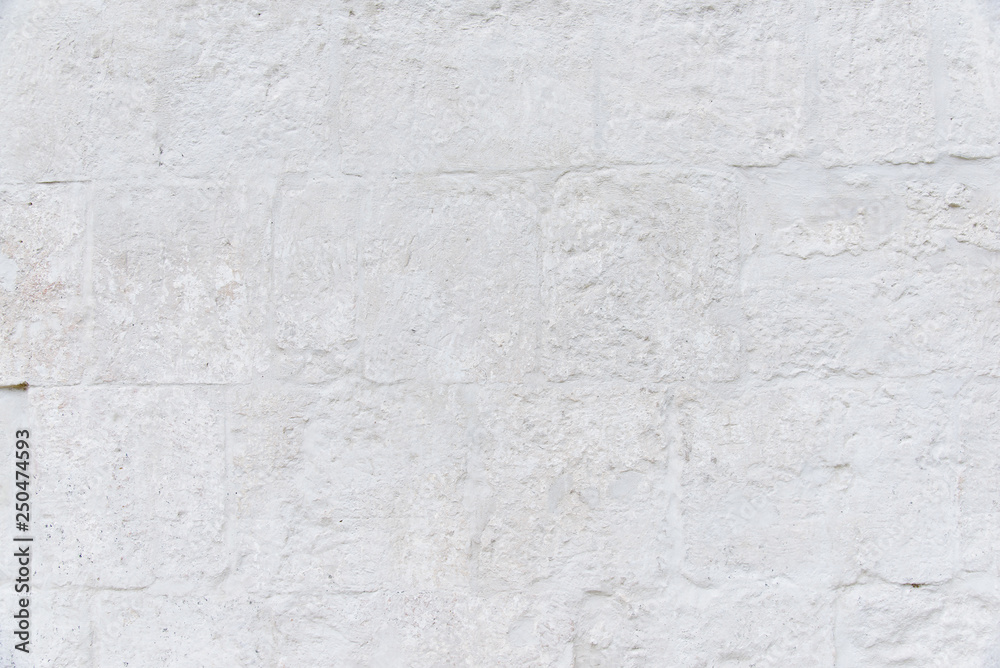 Grunge retro white background from old wall of stones. Texture of old painted white stone wall. Grunge retro white background from old wall of stones. Texture of old painted white stone wall.