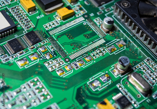 The motherboard of green color from the personal computer. Repair. Texture or background. Electronics. Spare parts. 