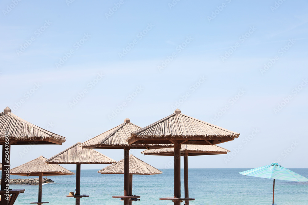 Beach umbrellas at tropical resort on sunny day