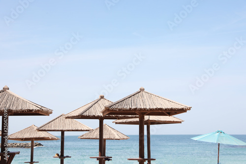 Beach umbrellas at tropical resort on sunny day