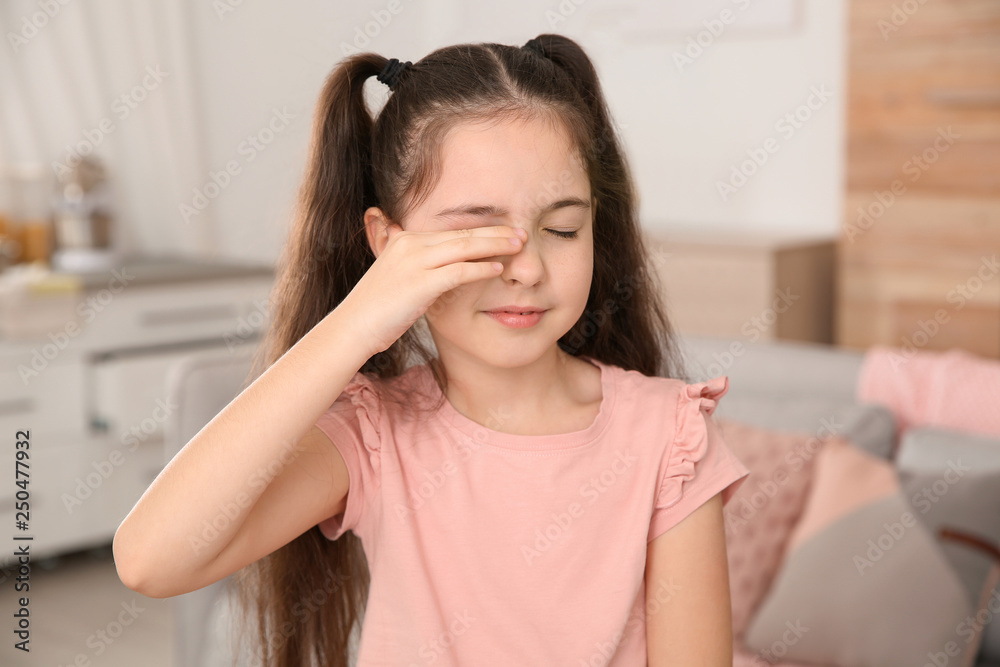 Little girl rubbing eye at home. Annoying itch Little girl rubbing eye at home. Annoying itch