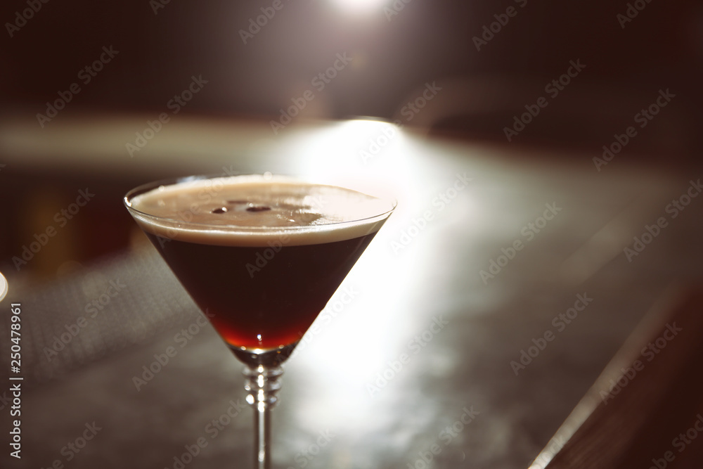 Glass of martini espresso cocktail in bar, closeup. Space for text